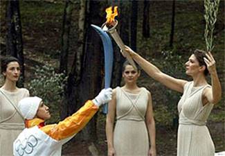 A person holding a torch with a sword

Description automatically generated
